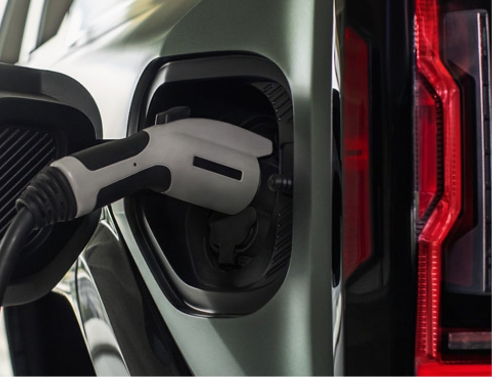 Close up of charging port with charger plugged in on a GMC Hummer EV SUV - Janssen GMC in NORTH PLATTE NE